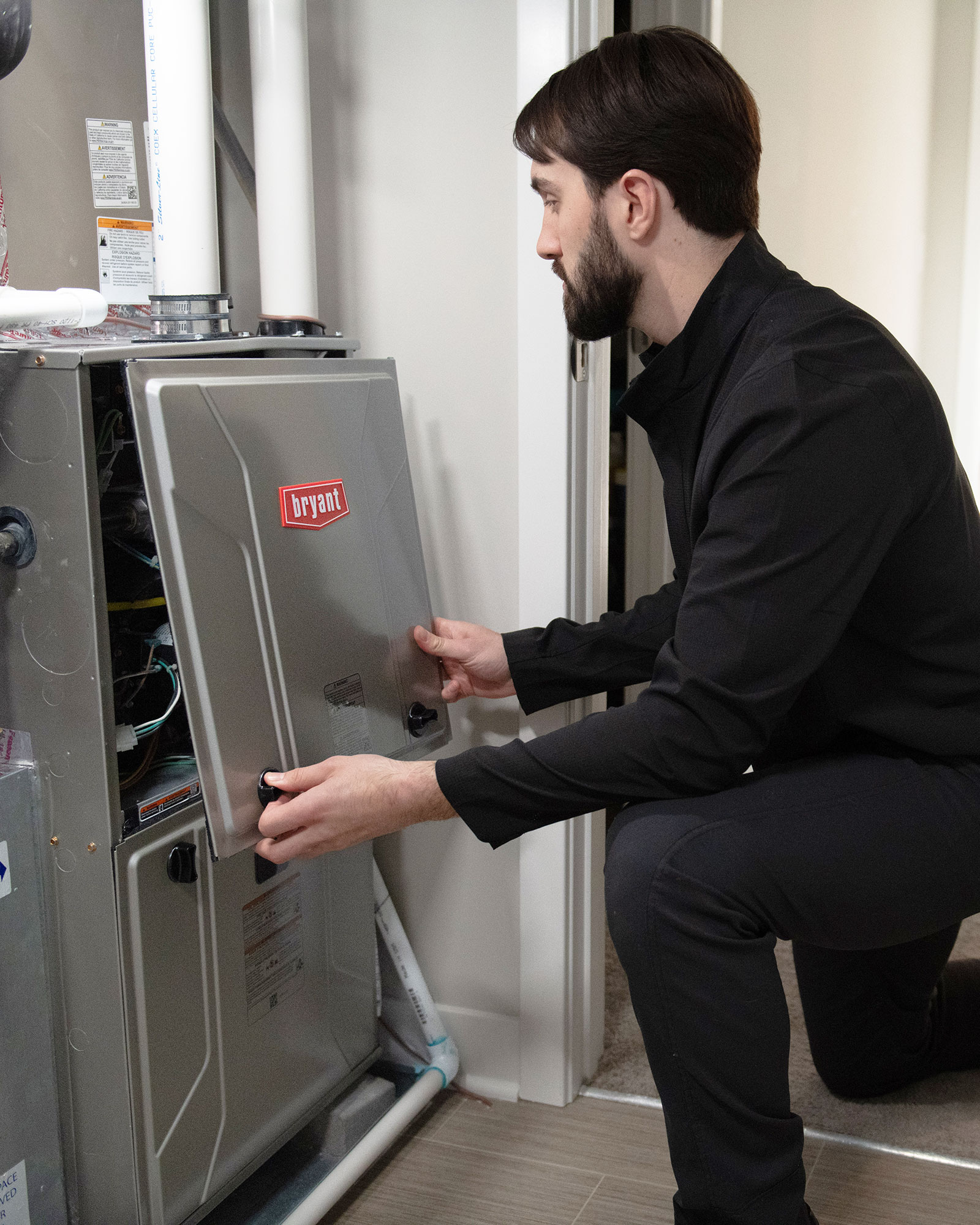 Technician servicing a Bryant furnace